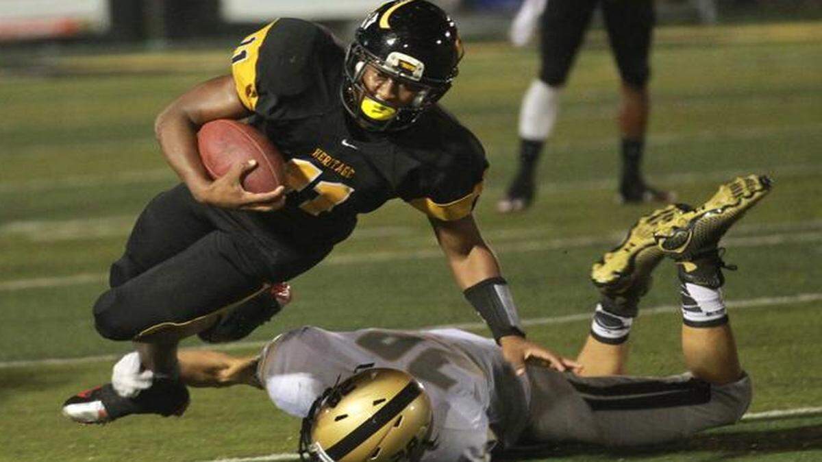
Kyshaun Bryan of Plantation American Heritage runs for yardage against visiting Orlando Bishop Moore in a Class 5A state semifinal game Friday, December 5, 2014. 
