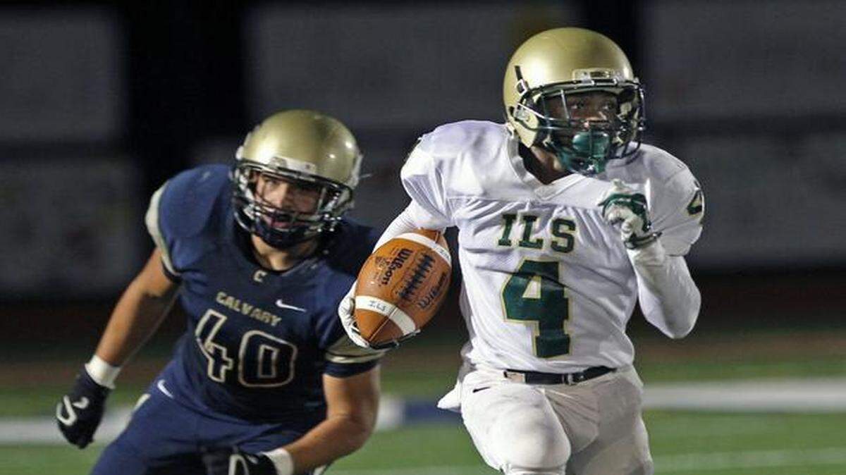 
La Salle‘s Manny Readon, right, breaks through Calvary Christian Academy's defense and out runs Tristan Peyton, left. La Salle played Calvary Christian in football in the SFC playoff game at Calvary Christian on Thursday, Oct. 23, 2014.
