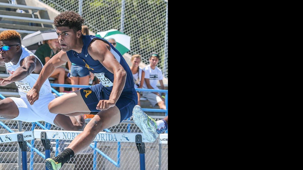 
St. Thomas Aquinas' Trevon Grimes clears a hurdle in the 110 Meter Hurdles Final during the Class 3A and 4A FHSAA Track and Field Finals held at University of North Florida in Jacksonville on May 2, 2014.
