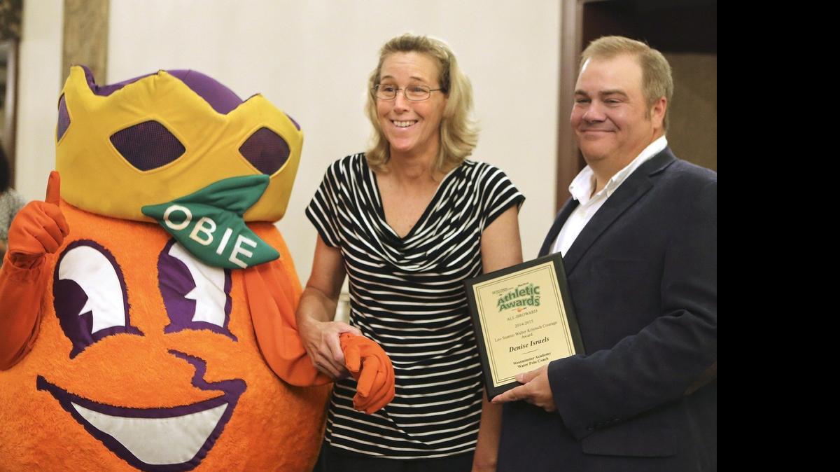 
Miami Herald sportswriter George Richards presents Westminster Academy girls’ water polo coach Denise Israels with the Courage Award at the All-Broward athletic awards Friday, May 22, 2015 at the Signature Grand in Davie.
