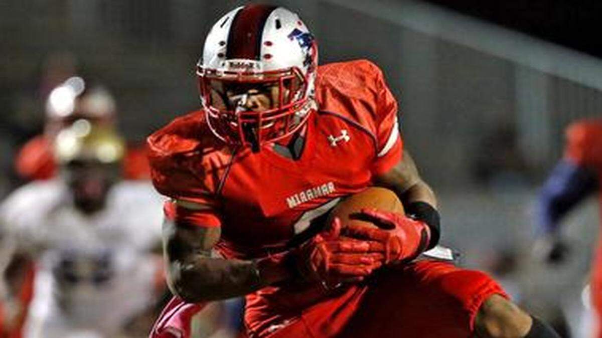 
Miramar receiver Khalil Lewis scores in the second quarter after breaking loose from Cypress Bay’s Danny Montoya at Miramar High School, Oct. 24, 2014.

