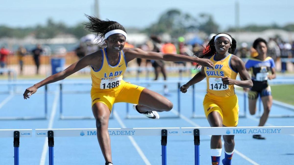 De’Andrea Young of Miami Northwestern overtakes Timetria Mitchel to win the Class 3A girls’ 300 meters on Saturday at IMG Academy in Bradenton.
