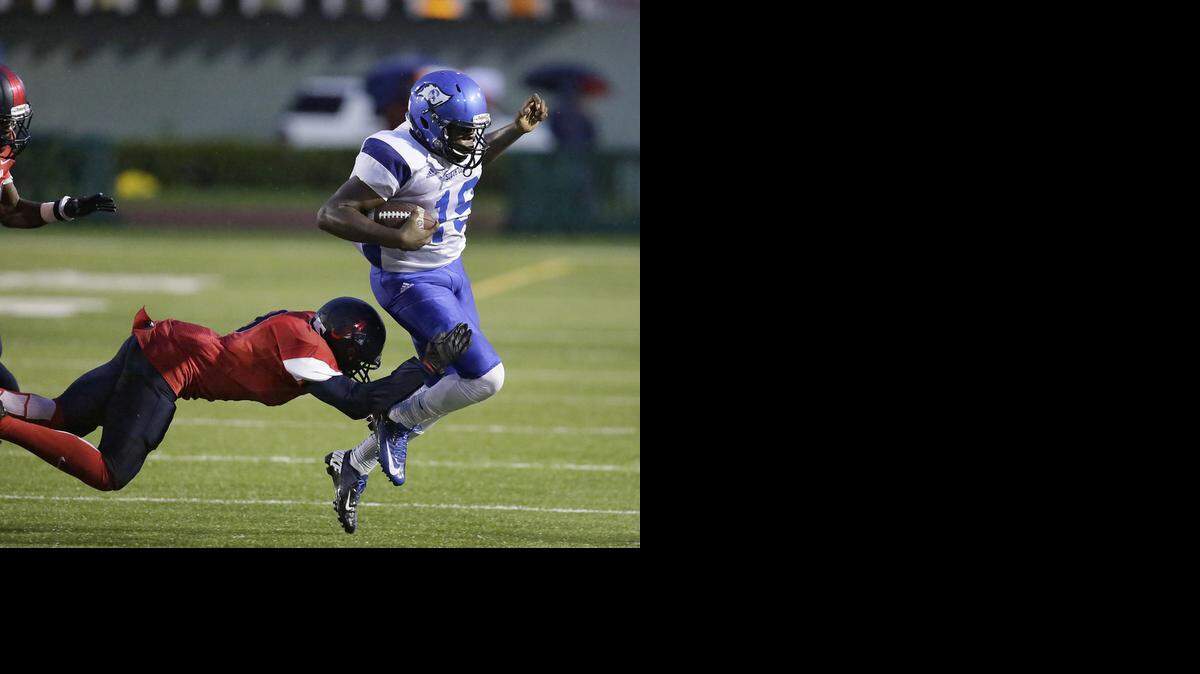 
South Dade Buccaneers quarterback P.J. Coats (19) runs with the ball during a high school football game against the American Patriots Thursday, Sept. 11, 2014, at Traz Powell Stadium in Miami.
