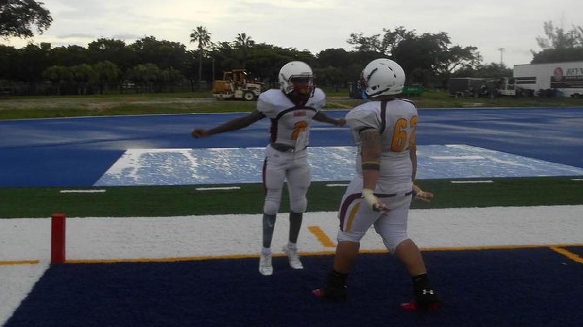 
Miami Springs offensive lineman Lazaro Daiz (62) congratulates quarterback David Bradley in the second quarter.
