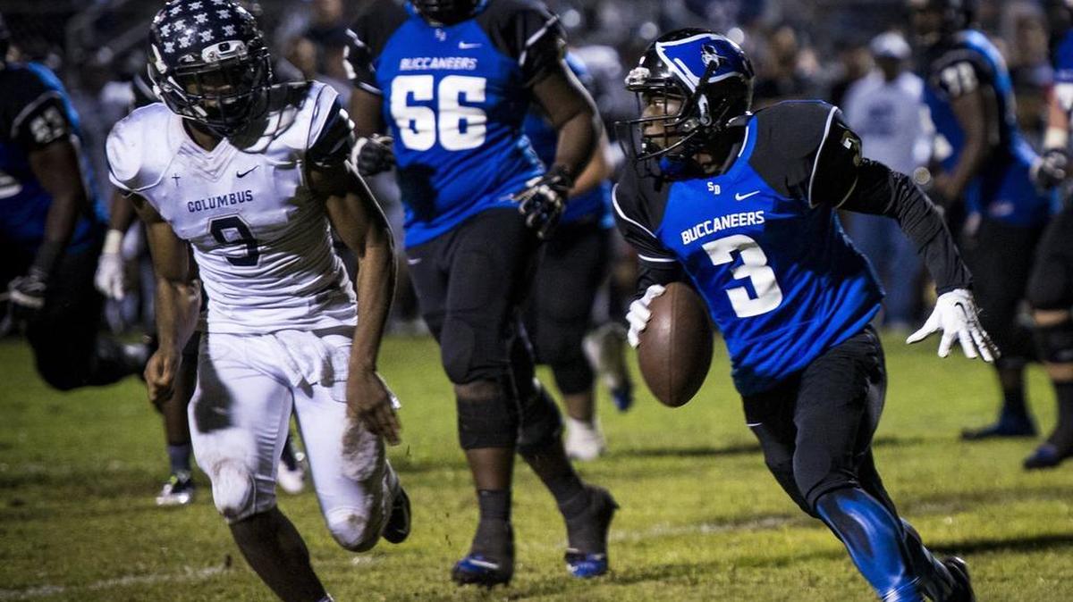 Columbus defensive end Joshua Uche (9) chases South Dade quarterback Ludovic Saintvil in the Region 4-8A football final at Harris Field on Friday, Nov. 27, 2015.