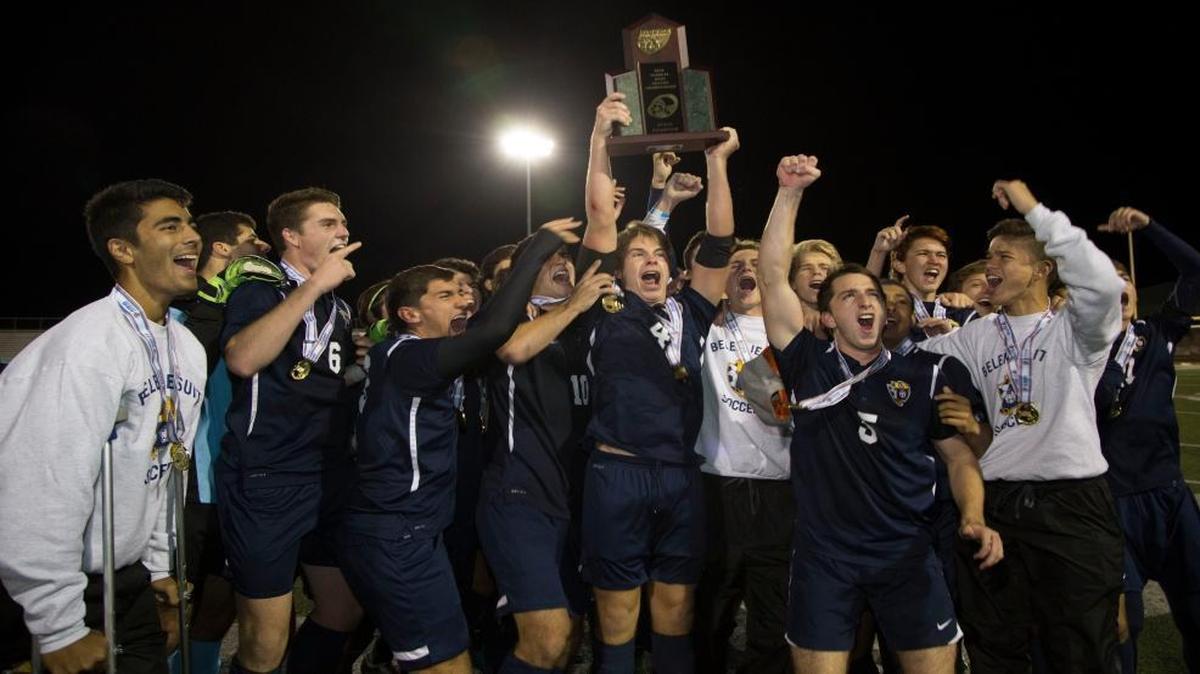 Belen Jesuit players celebrate with their trophy after wrapping up their first boys’ soccer state championship with a 5-2 victory over Naples Gulf Coast on Friday, Feb. 12, 2016, in Melbourne.