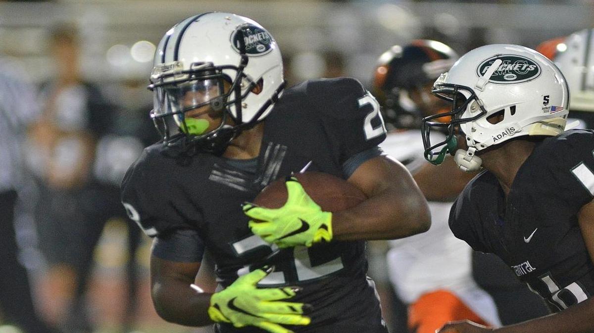 
Miami Central running back Robert Khori carries the ball in the first half of a high school football game Saturday night Sept. 26, 2015 against Booker T. Washington high school.
