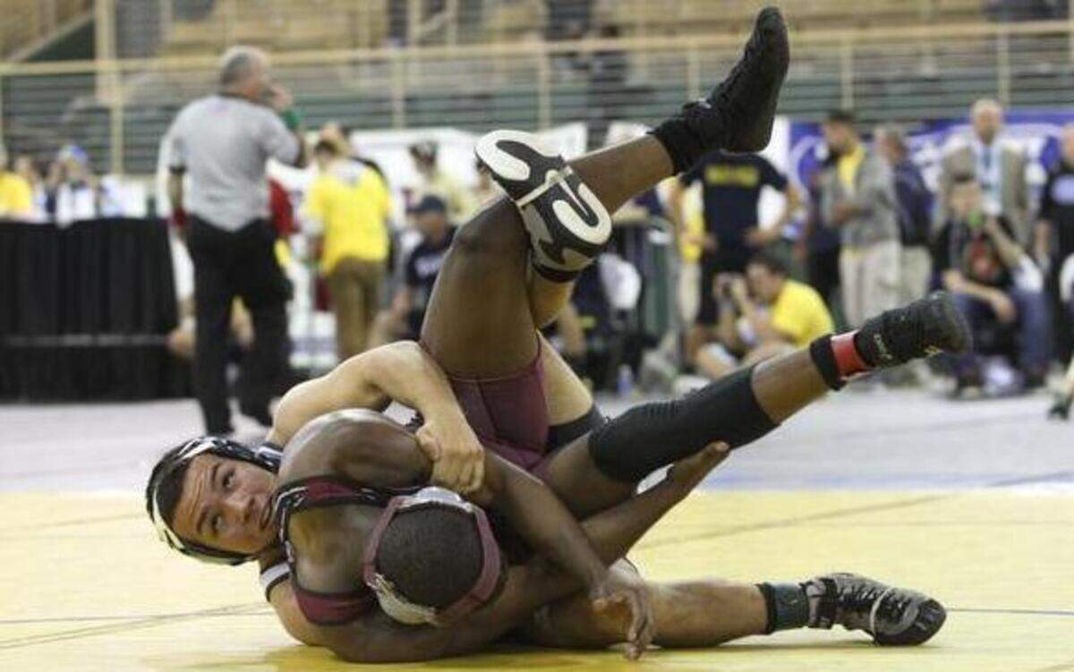 
South Dade’s Justin Ramirez, left, wrestles Robert Sherman-Young of Lake Worth in the 145-pound class in Class 3A. 
