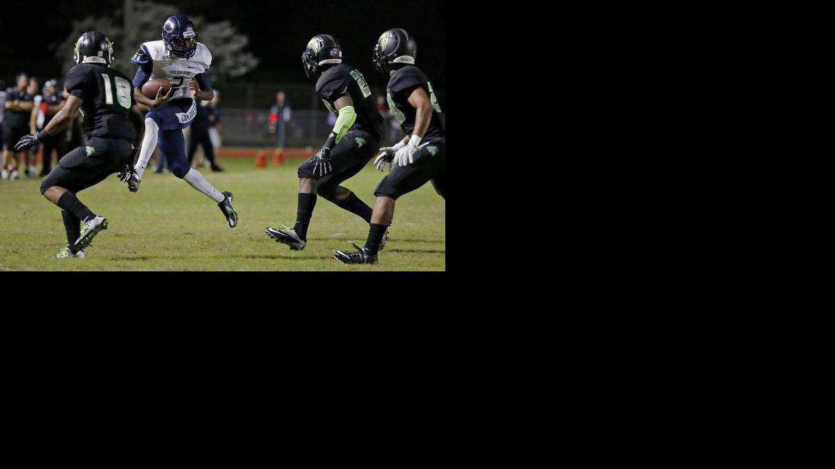 
Columbus' Ivan Smith (2) runs against Flanagan in Pembroke Pines on Friday, Dec. 5, 2014.
