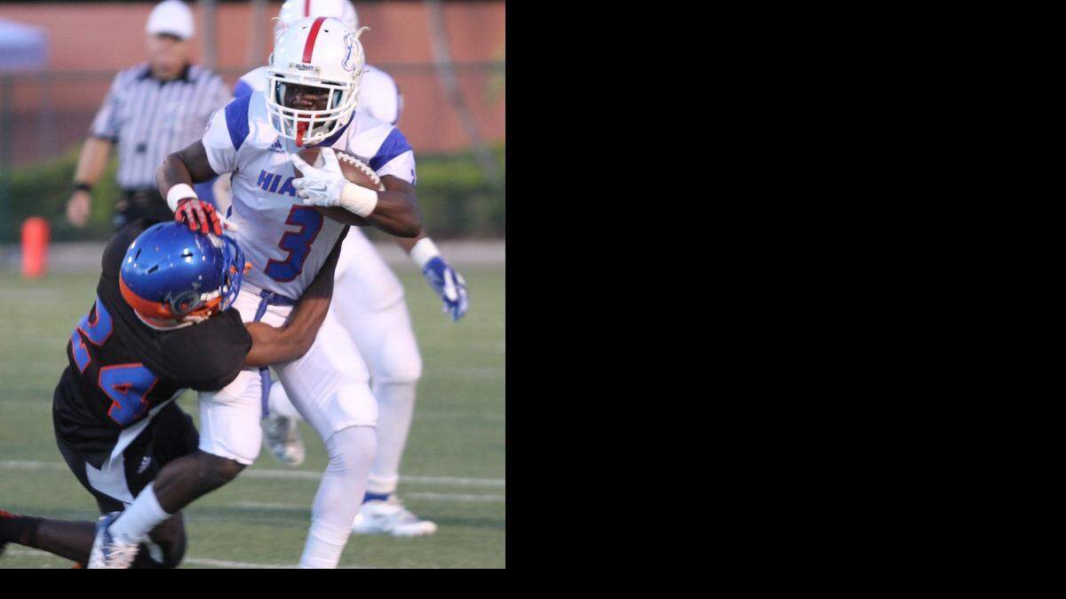 
Hialeah-Miami Lakes cornerback Christopher White (#24), attempts to take down Hialeah running back Lynn Bryant (#3), during a football game on Friday, Sept. 12, 2014.
