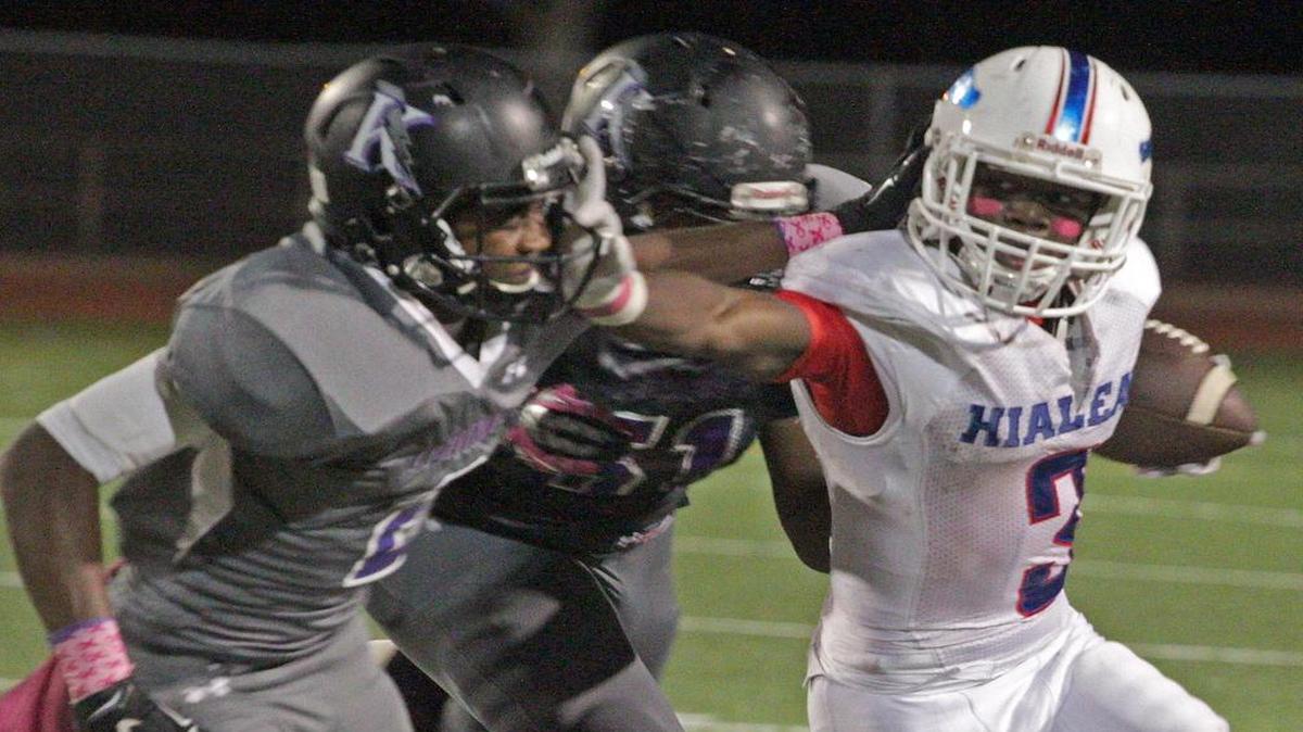 Hialeah tailback Lynn Bryant (155 yards) stiff-arms a Krop defender during the T-Breds’ 29-25 win Thursday night.