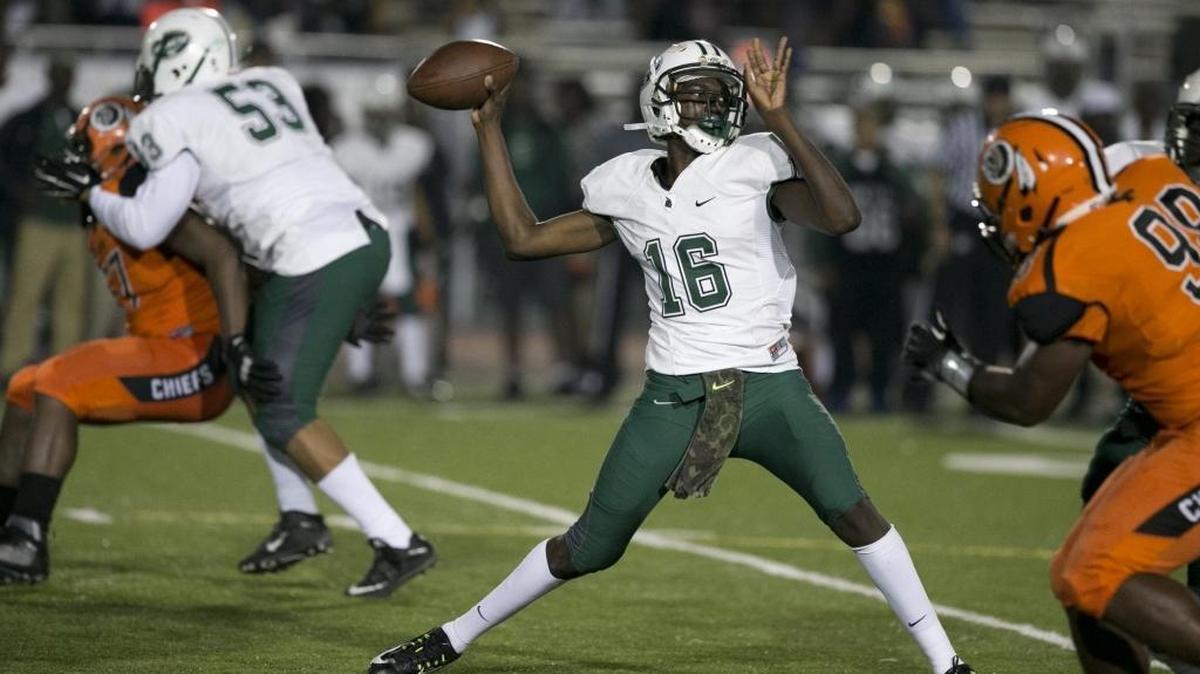 Central QB Jerrod Thomas sets up to pass in the second quarter in a regional semifinal against Carol City at Traz Powell Stadium on Friday, Nov. 20, 2015.