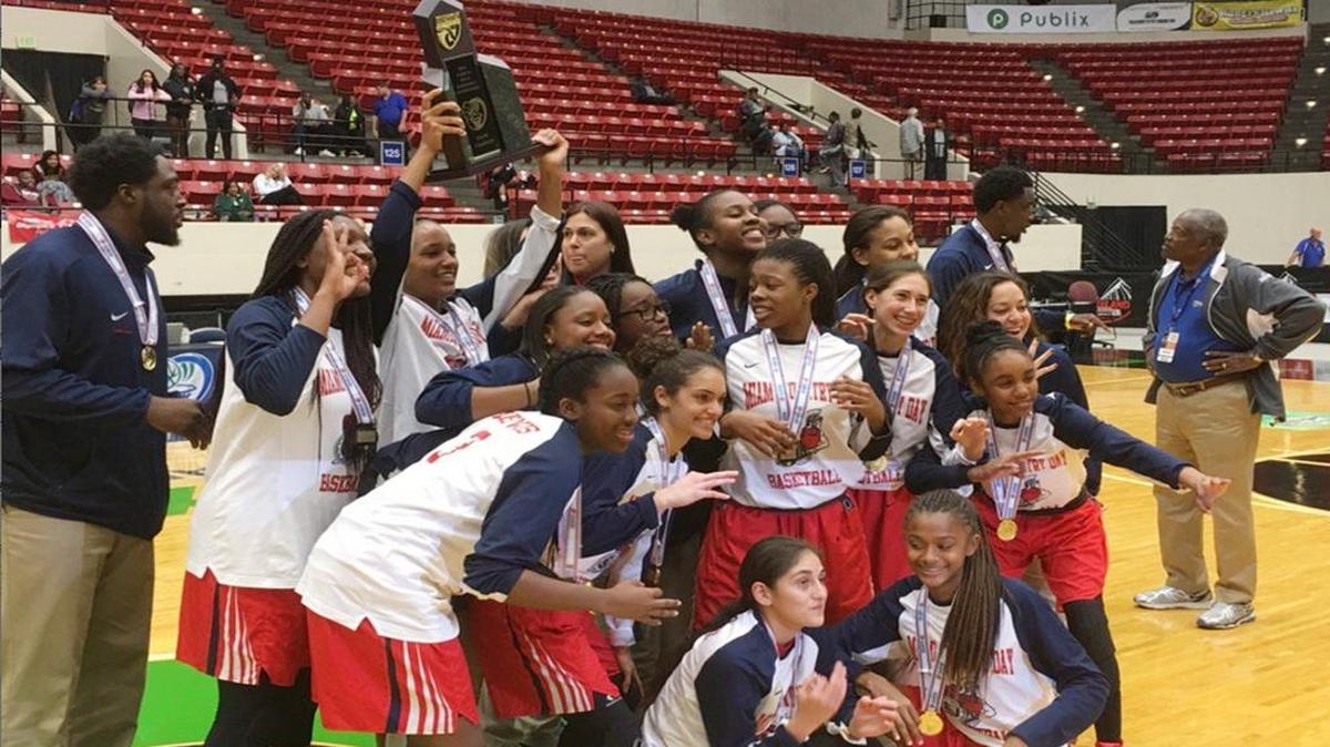 Miami Country Day players celebrate after defeating University Christian on Thursday, Feb. 18, 2016 for the Spartans’ third Class 3A state title in a row.