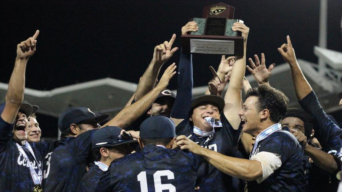 
Columbus players hold up the trophy after defeating Orange City University in the Class 8A title game.
