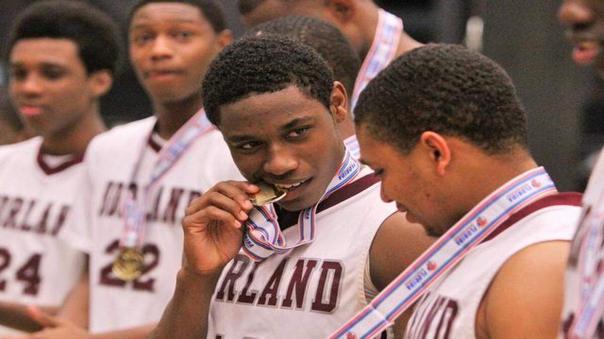 
As the rest of his team receives their medals, Norland'sTyrik Waite makes sure it’s real after winning the state title against Gainesville during the FHSAA Boys 6A Basketball championship Saturday February 28, 2015 in Lakeland.
