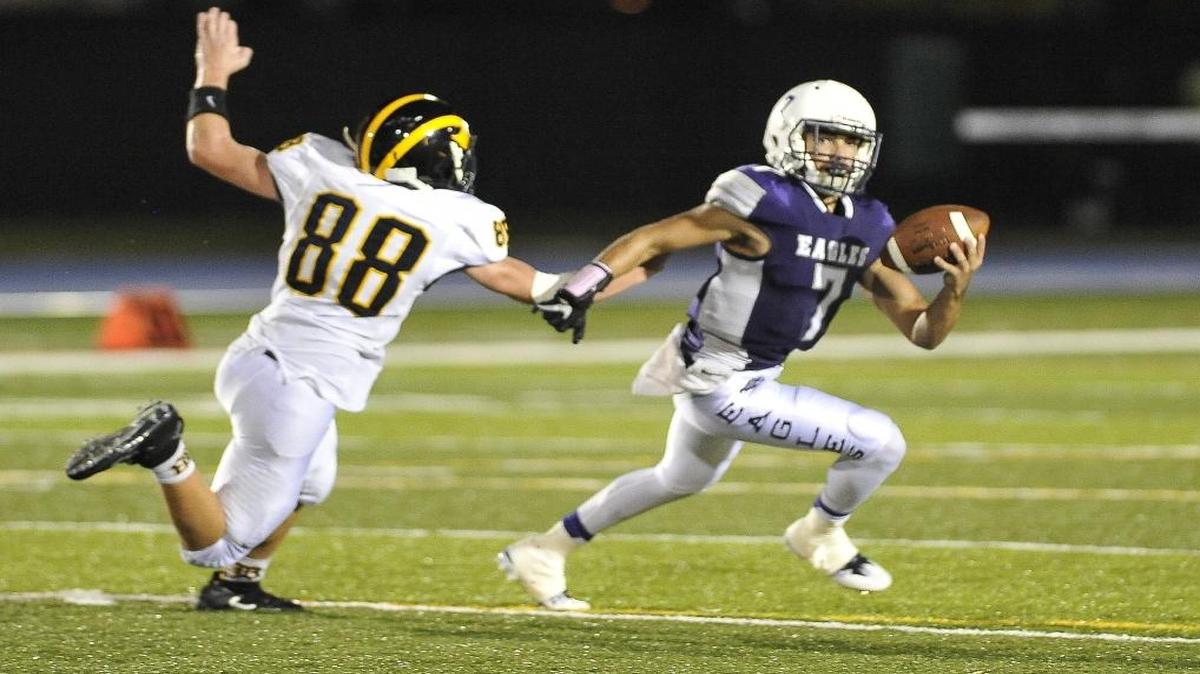 Quarterback J.J. Jaramillo scrambles away from a Belen Jesuit defensive player during a game on Sept. 29, 2016. On Oct. 29, Jaramillo threw for three touchdowns and 123 yards on 8 of 10 attempts and also ran for a touchdown in a victory over Braddock.