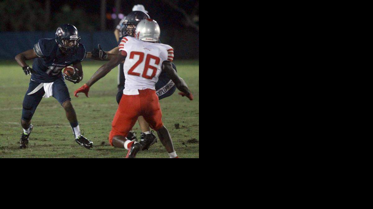 
Making a move: Columbus High’s Jerron Rollins, left, takes the ball on a reception and runs with it for a gain against Coral Gables during a key victory Friday night at Tropical Park. Rollins had three catches.
