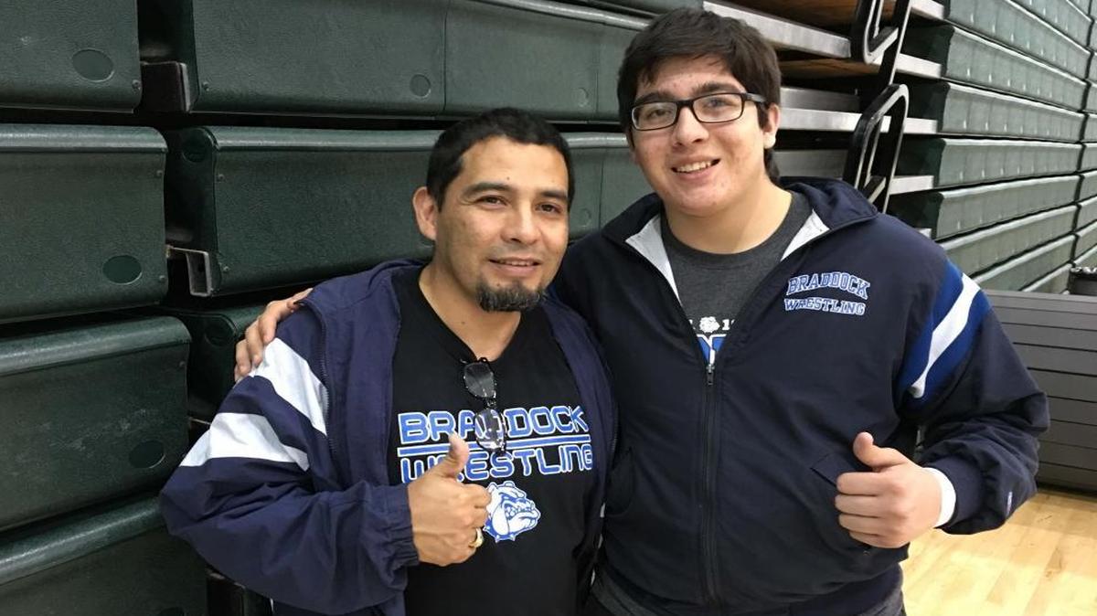 Braddock wrestling coach Saul Tejada, left, poses with his son, Saul Jr., at the GMAC championships last week.