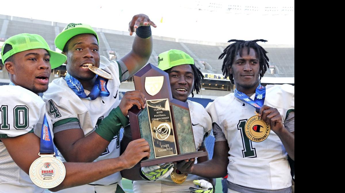 
From left, Central’s Olin Cushion III, Fermin Silva, Anthony Jones and Da’Vante Phillips hold the trophy after defeating Seffner Armwood in the Class 6A title game for the Rockets’ third championship in a row.
