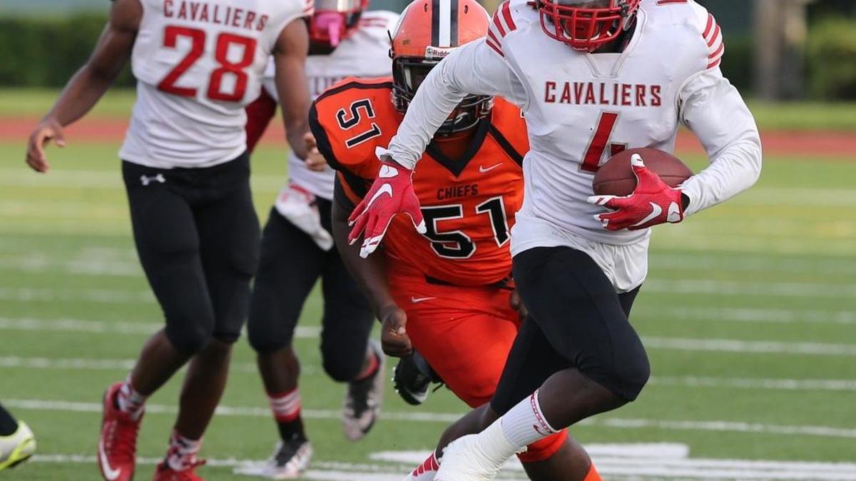 
Miami Carol City 's Montrell Newton chases Coral Gables’ Kevin Romer in the first half at Traz Powell Stadium on August 27, 2015.

