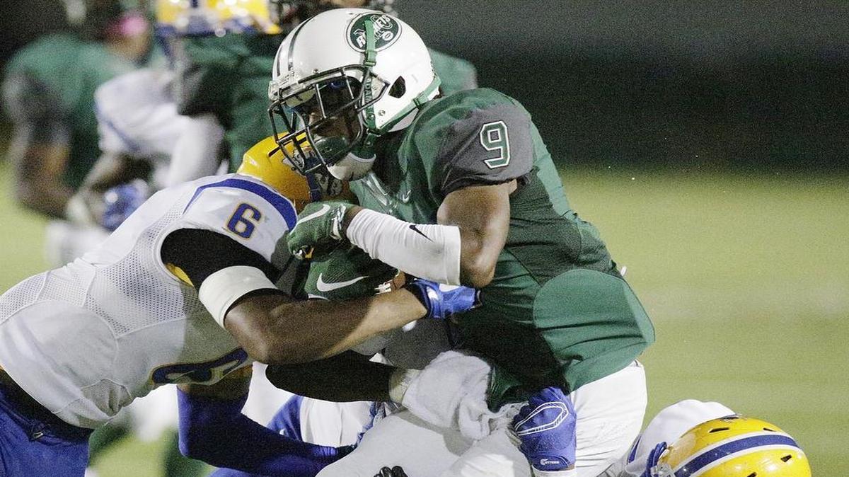 
Central’s Jernard Phillips fights off a group of Northwestern defenders during Saturday night’s crucial victory for the Rockets over their rivals. 
