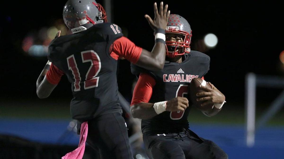Coral Gables’ Gilbert Frierson (12) greets Robert Brown in the end zone as Brown scores during the second quarter of the Cavaliers’ big victory over Columbus on Friday, Oct. 30, 2015.