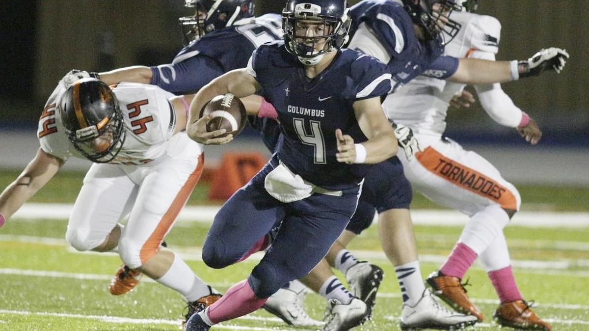 Columbus quarterback Alex Ros scrambles against Booker T Washington on Friday, Oct. 23, 2015 at Tropical Park Stadium in Miami.