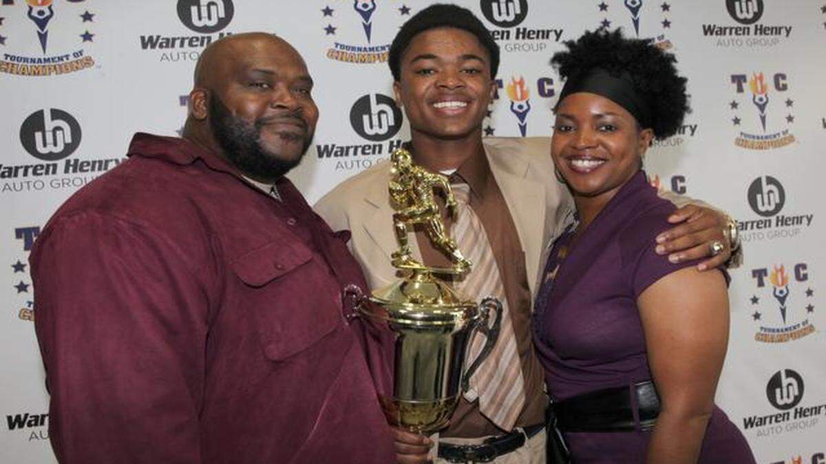 
Proud parents: North Miami senior quarterback Hilton Joseph poses with parents Terry, left, and Aliette Joseph after after receiving the South Florida High School Football Player of the Year Award. 
