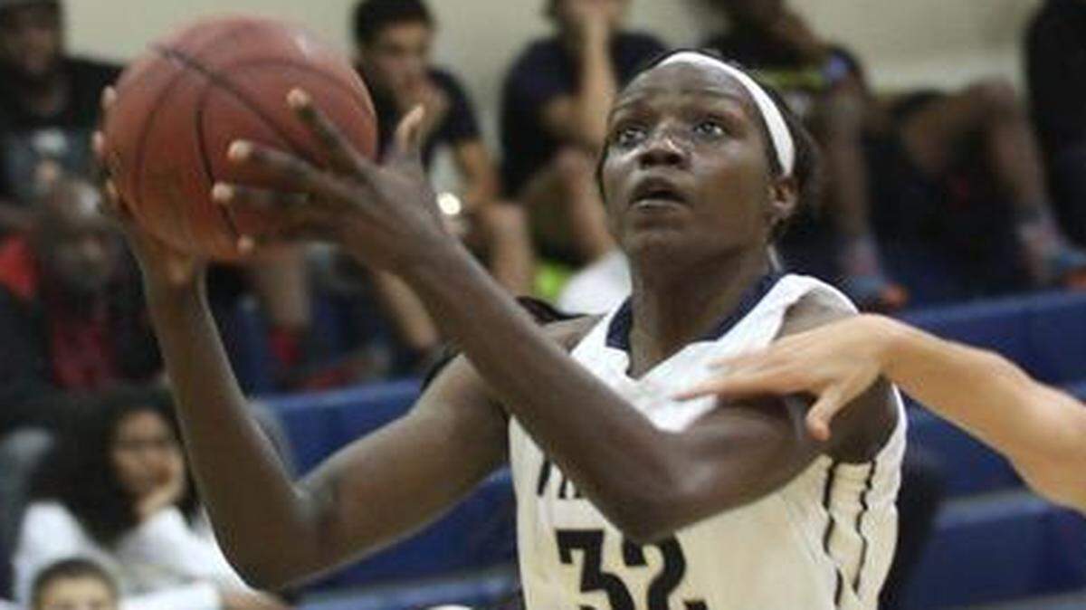 Miami High’s Beatrice Mompremier drives to the basket against Ferguson in the GMAC championship. 
