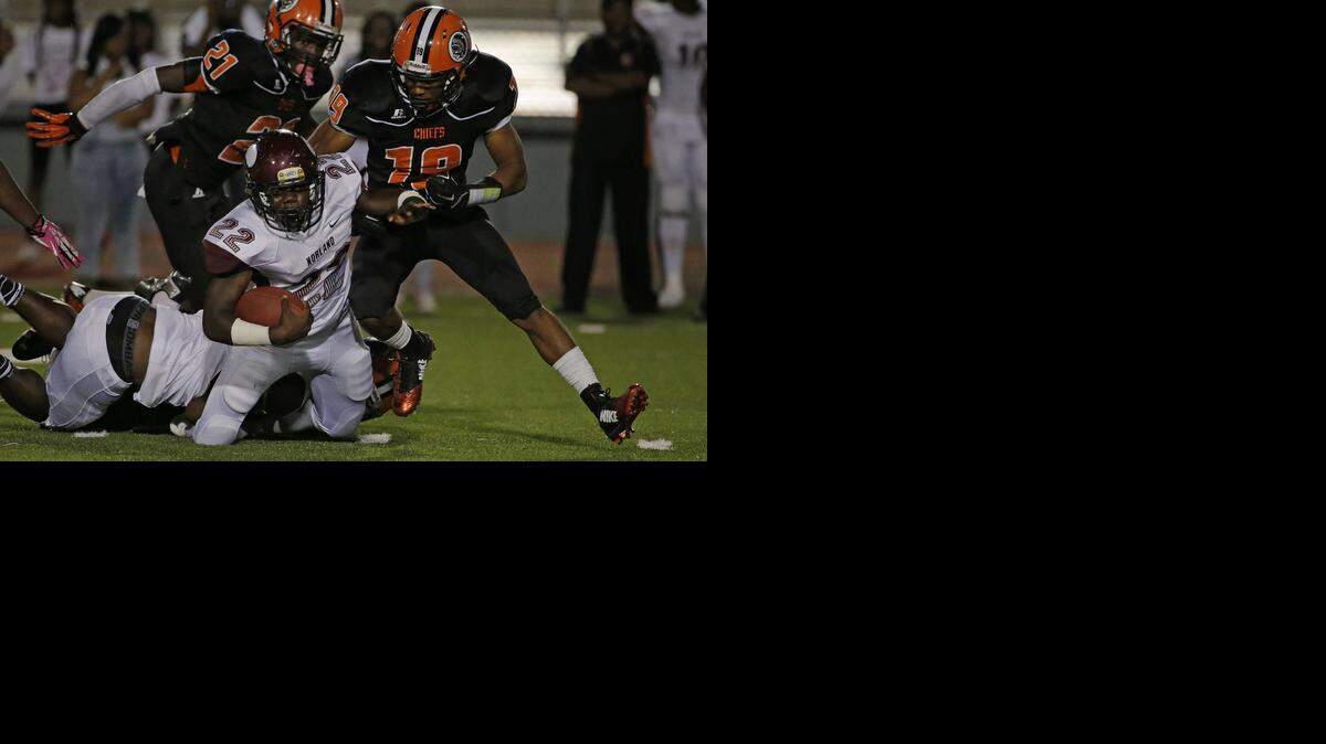 
Carol City's Joevon Henry (19) tackles Norland's Chavis Wright (22) in Miami on Thursday, Oct. 30, 2014.
