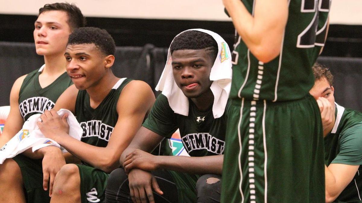 Westminster Christian players show their dejection during a 41-38 loss to Melbourne Holy Trinity in a Class 4A boys’ basketball state semifinal game at The Lakeland Center on Wednesday, February 24, 2016.