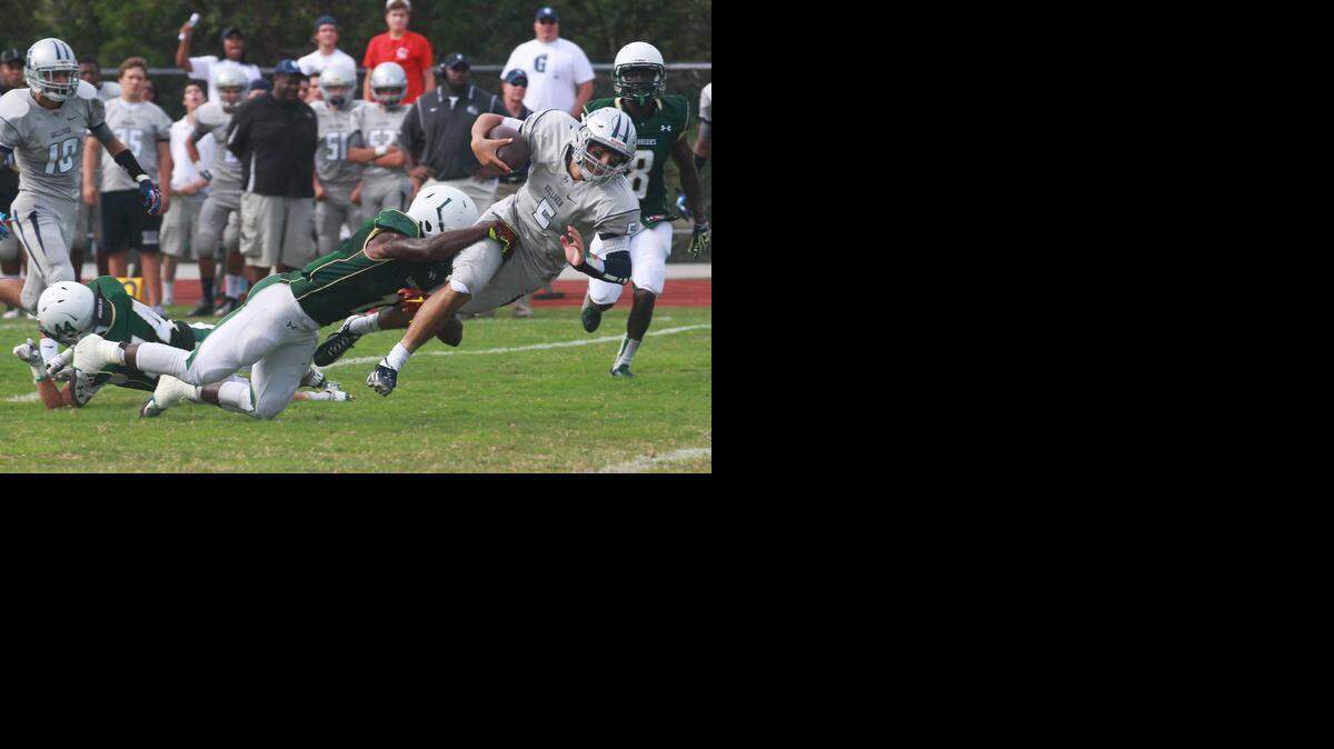 
Anthony Hasan #5 of Gulliver High runs for yards in their game against Westminster Christian High, Friday, Sept. 26, 2014, at Westminster Christian.
