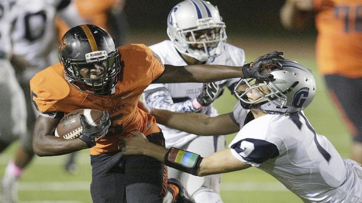 
The Tornadoes’ Trawone Johnson tries to escape a tackle during Booker T.’s rout of Gulliver on Thursday night.

