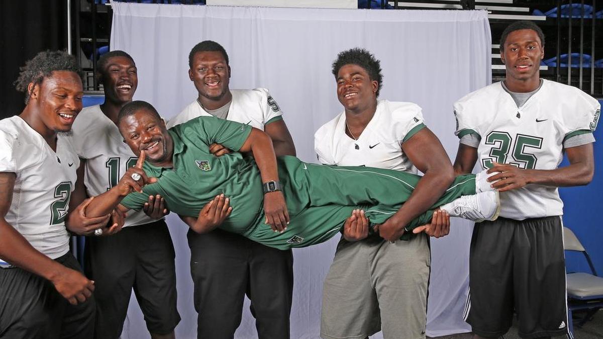 
Coach’s support system: Roland Smith, coach of three-time defending state champion Central, is carried by some of his players — from left, Donovan Thompson, Jerrod Thomas, Navaughn Donaldson, Keir Thomas and Jamel Cook — during a light moment at the Dolphins’ high school football media day.
