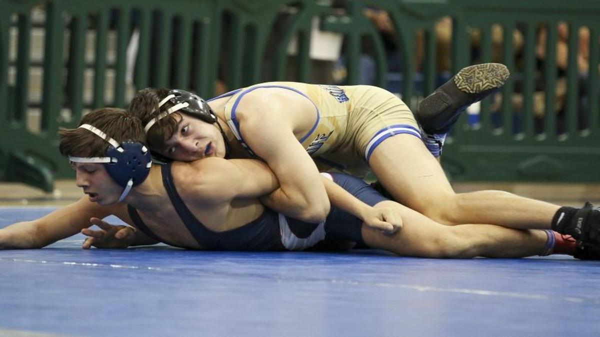 South Dade’s Peter Webb, top, wrestles Edgar Martinez of Columbus High during the GMAC Wrestling Championships at Ronald W. Reagan High School on Feb. 6, 2016.
