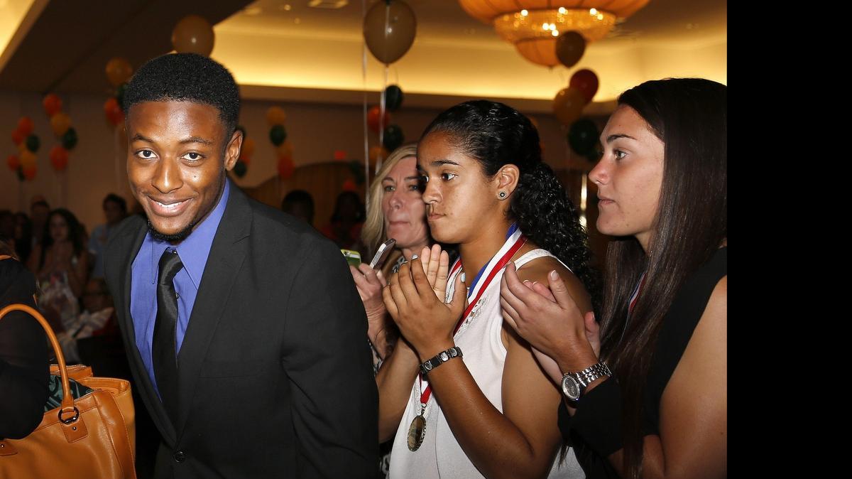 
Coral Reef's Fred Mathieu gets a standing ovation while heading onstage after winning the Leo Suarez/Walter Krietsch Courage award during the All-Dade Athletic Awards at Jungle Island on Wednesday, May 20, 2015.
