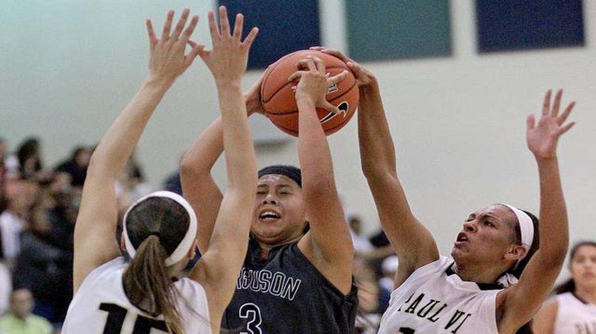 
Surrounded: Ferguson’s Annie Osceola, center, heads to the basket but is blocked by Paul VI’s Kendall Hunter (15) and Dominique Webster on Tuesday night.

