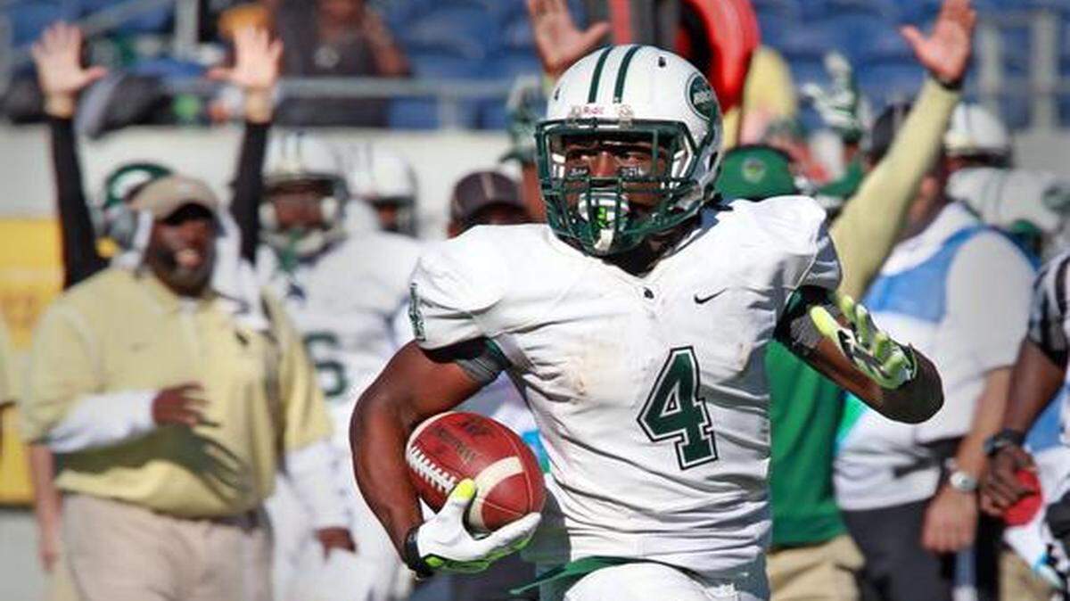
Miami Central’s Anthony Jones runs the ball in the second quarter as they play Armwood in the 2014 Class 6A Boys Football Championship at the Citrus Bowl in Orlando, Florida, December 13, 2014.
