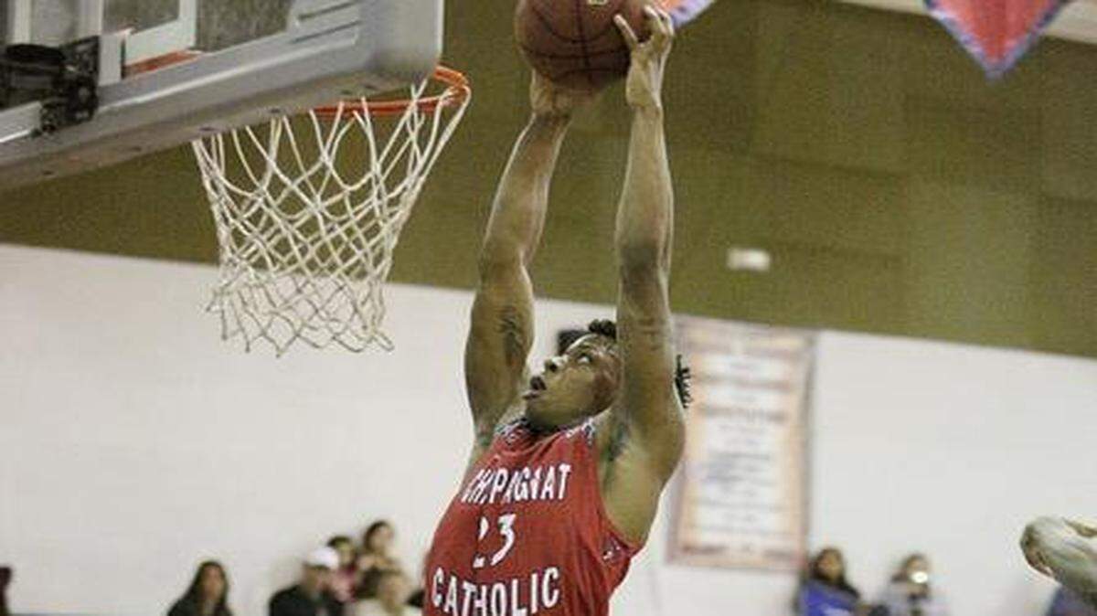 
Champagnat Catholic’s Oswald Parker throws down two of his 25 points. He also had 10 rebounds Saturday. 
