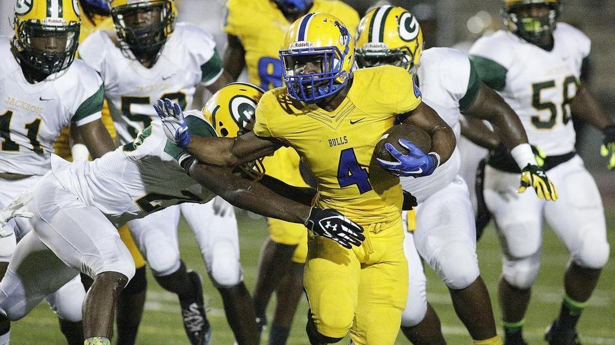 Northwestern running back Corey Lane tries to escape a tackle attempt during the annual “Soul Bowl” on Friday, Nov. 6, 2015 at Traz Powell Stadium in Miami.