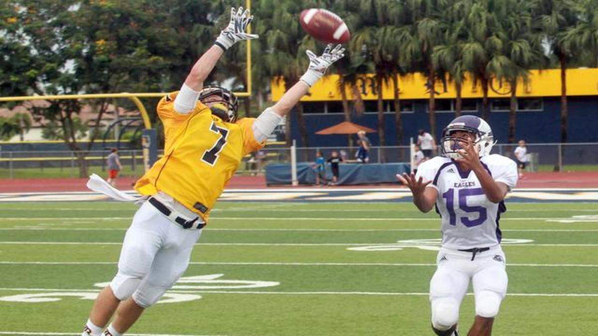 
Francisco Castellanos, (7) of Belen Jesuit, jumps for a missed interception in their game against Southwest High, Friday, Sept. 19, 2014, at Belen Jesuit in West Miami. Manny Pineda, (15) of Southwest did not catch the ball.
