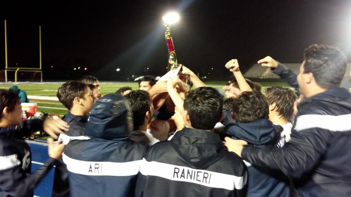 The Reagan High boys’ soccer team celebrates after beating Ferguson 4-3 in overtime to win the GMAC title on Thursday night at Tropical Park.