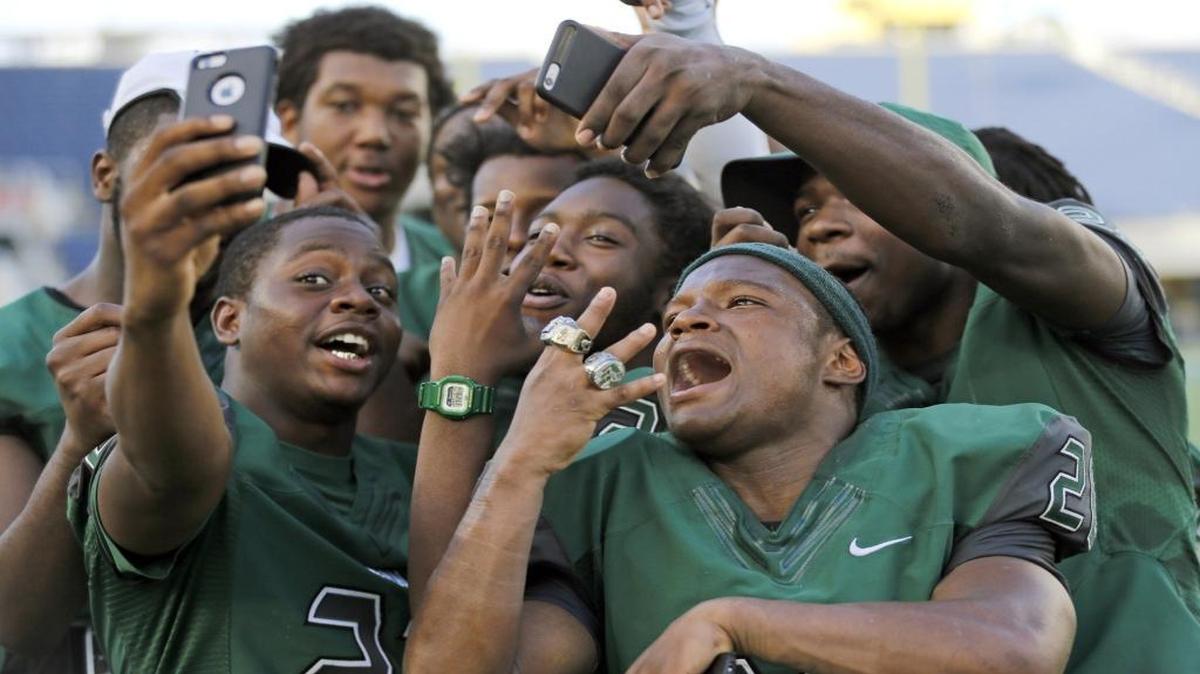 Miami Central's Peterson Joseph shows off his state championship rings after defeating Seffner Armwood at the 2015 FHSAA Football Class 6A Championship at the Citrus Bowl in Orlando on Saturday, December 12, 2015.