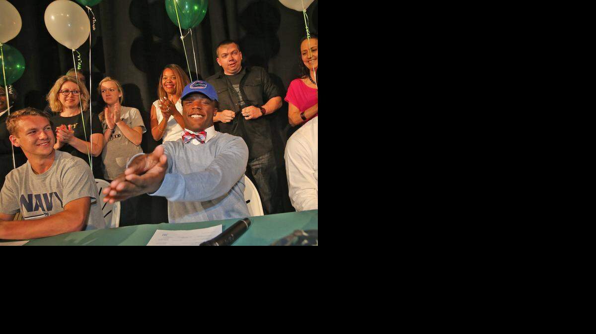 
Westminster Christian running back Jordan Cronkrite makes his decision to go to the University of Florida on Wednesday February 4, 2015. Westminster Christian soccer player Eli Medder (at left) will attend the Naval Academy.
