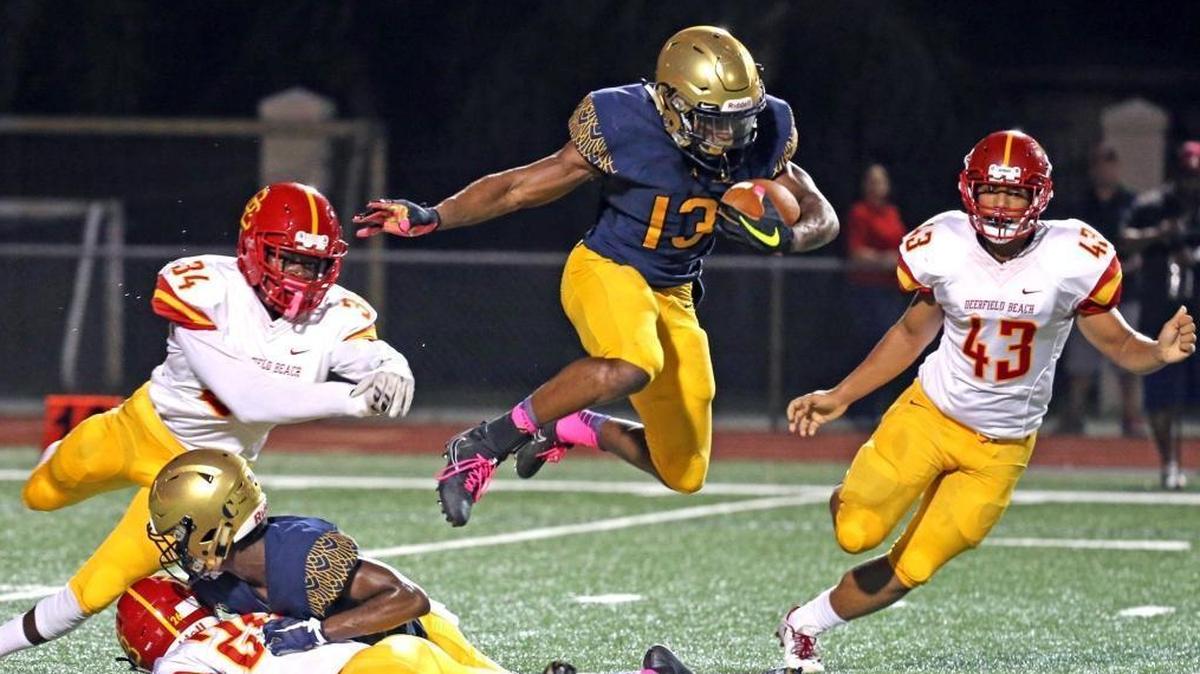 St. Thomas Aquinas cornerback Asante Samuel leaps over a Deerfield Beach player Oct. 6, 2017. He signed with Florida State.