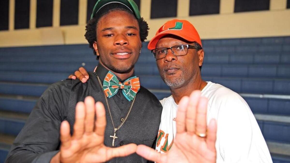 St. Thomas Aquinas’ Alphonso Blades with his uncle Brian Blades, a former University of Miami football player, after Alphonso committed to UM at National Signing Day at St. Thomas Aquinas High School, Feb. 7, 2018.