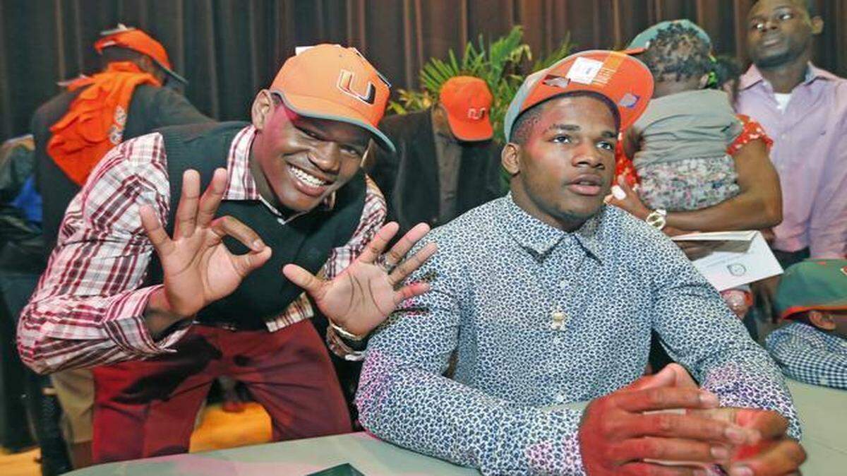 
James King and Mark Walton celebrate after signing with the University of Miami during National Signing Day at Booker T. Washington on Wednesday, February 4, 2015.
