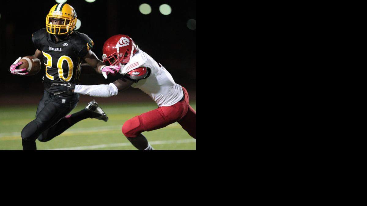 
Jackson’s Xavier Bailey returns a kickoff as Cardinal Gibbons’ Jonathon Graham defends at Traz Powell Stadium on Saturday, Oct. 19, 2013.
