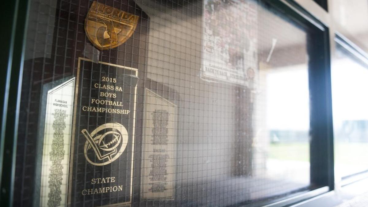 Flanagan proudly displays the 2015 state championship trophy in football, the first at the school. The Falcons aim to defend their Class 8A state title under a new coach, Stanford Samuels II.
