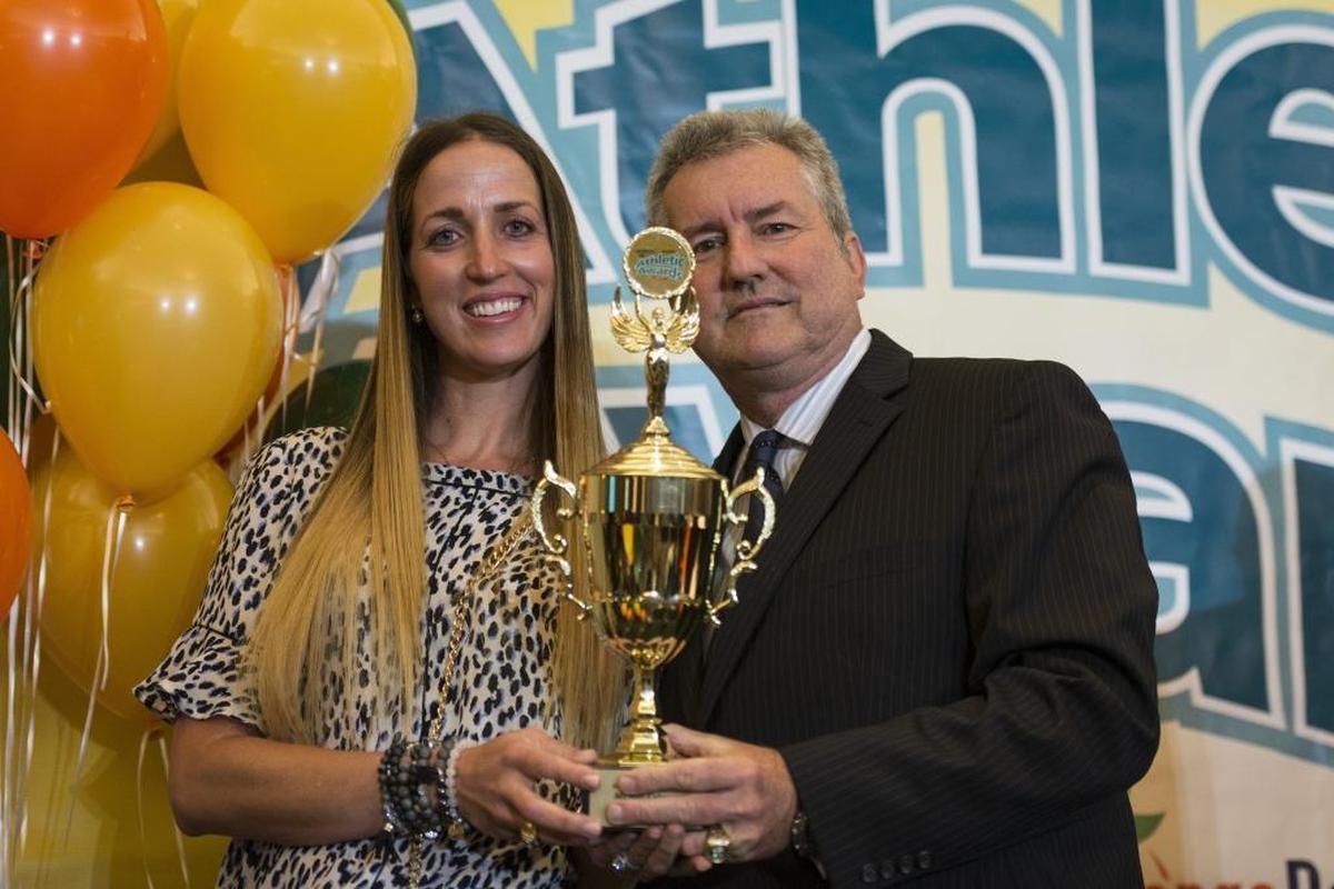 Miami Herald sportswriter Bill Daley presents Westminster Volleyball Coach Julia Doan with the Miami-Dade Coach of the Year Award at the Miami Herald Miami-Dade Student Athletic Awards Ceremony on Tues., May 23, 2017.